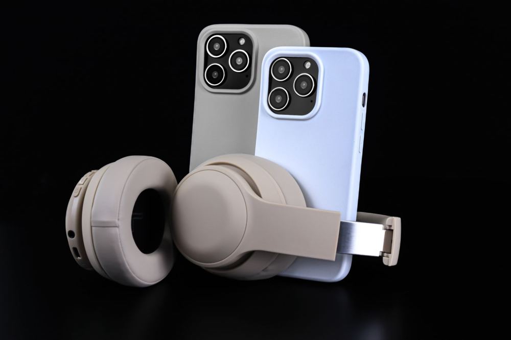 Wireless headphones next to two smartphones