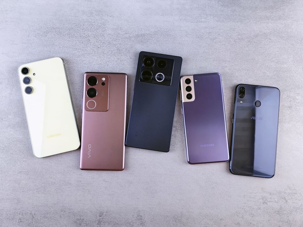 Several Android smartphones laid out on a table